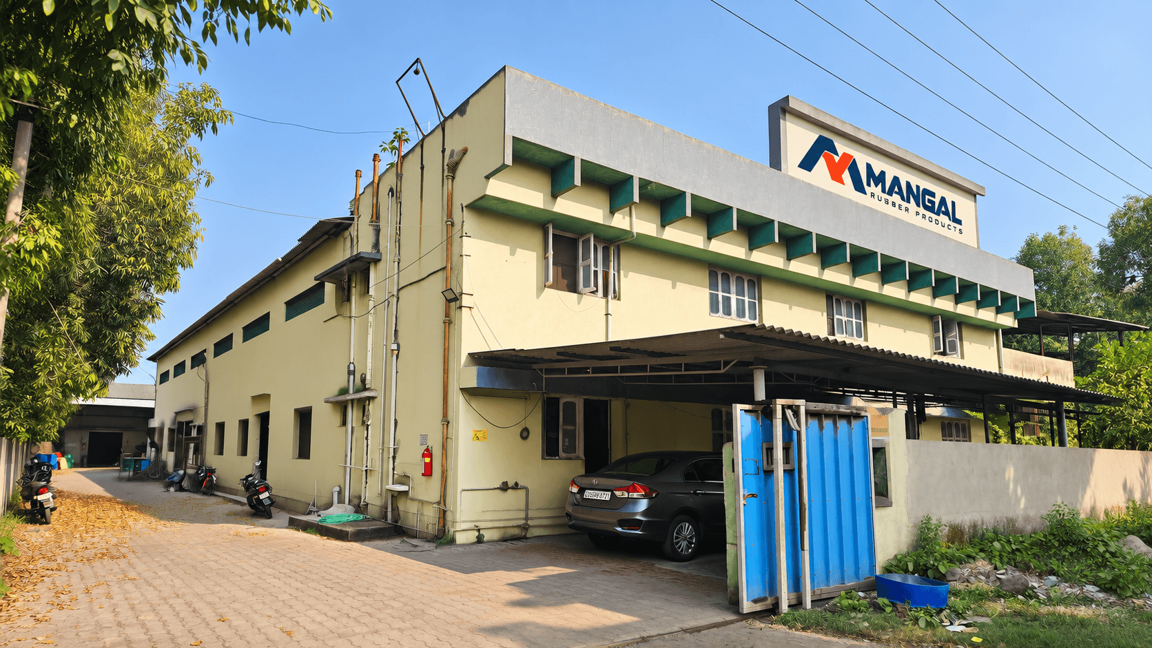 The Mangal Rubber Products Pvt Ltd plant at New GIDC, Gundlav, Valsad, with the Mangal sign on the roof
